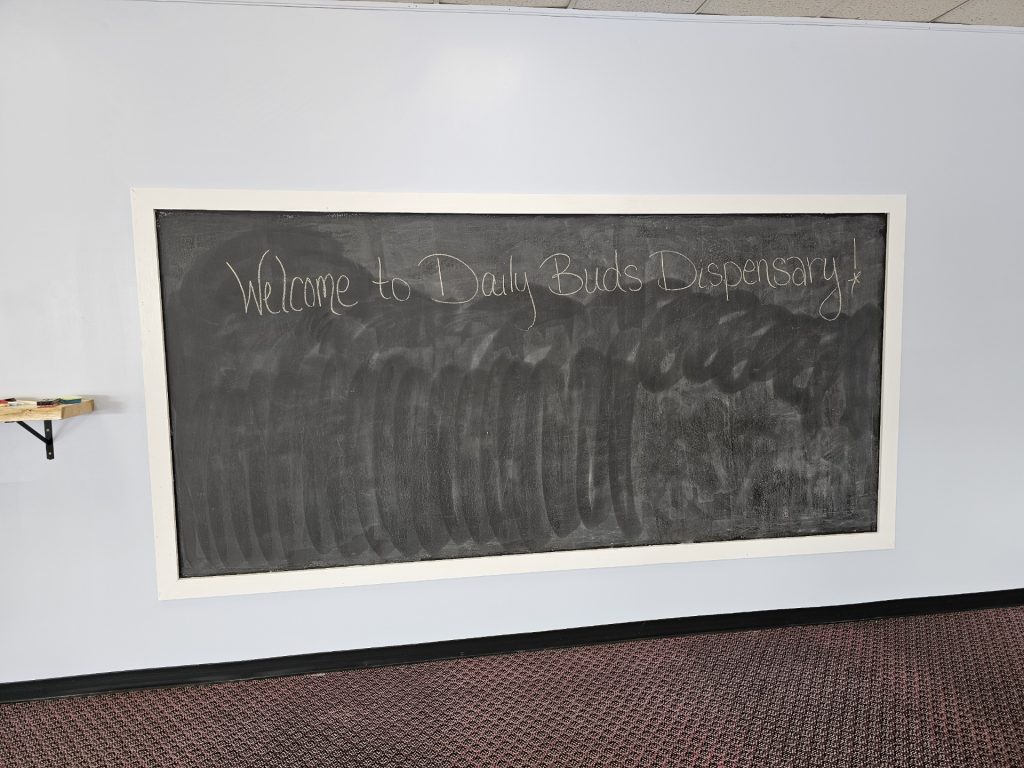 Welcome chalkboard inside Daily Buds Dispensary in Winslow, Maine