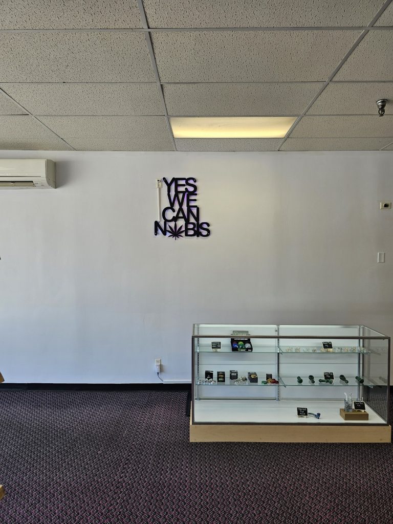 Yes We Cannabis wall sign and display case inside Daily Buds
